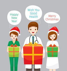 Doctor And Nurse Holding Gifts Box In Christmas