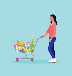 Woman Pushing Shopping Cart Full Of Groceries