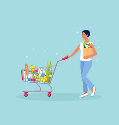 Woman With Paper Bag Pushing Shopping Cart Full