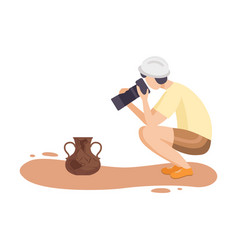 Female Archaeologist Researching And Photographing