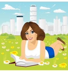 Woman Lying Down On Grass Reading Book