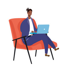 Afro Ethnic Man Using Laptop Seated In Sofa