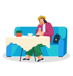 Young Woman Sitting On Blue Couch At A Table