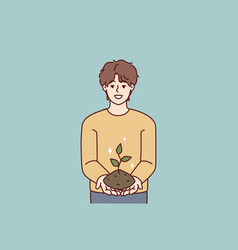 Smiling Teenage Boy Holding Earth With Growing