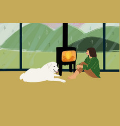 Woman Sitting With Her White Dog By The Fireplace