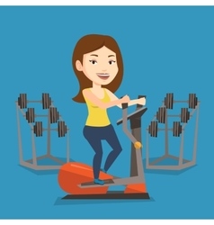 Woman Exercising On Elliptical Trainer