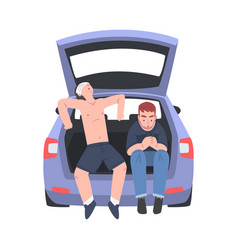 Two Man Sitting In Car Trunk Resting