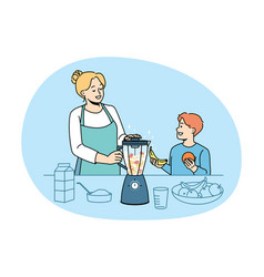 Happy Mom And Son Make Fruit Smoothie In Blender