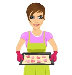 Woman Holding Baking Tray With Heart Shape Cookies