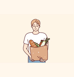 Smiling Man Holding Bag With Groceries