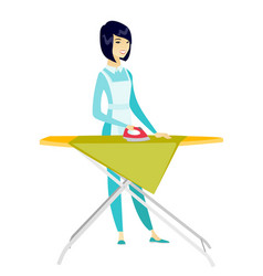 Asian Maid Ironing Clothes On Ironing Board