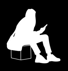 Woman Sitting On Box Looking At Mobile Phone