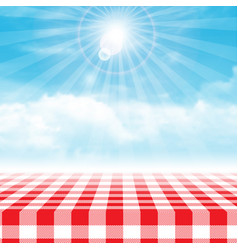 Gingham Picnic Table Against Blue Cloudy Sky