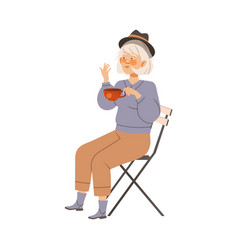 Senior Woman Sitting In Chair And Drinking Coffee