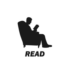 Young Man Sitting On Sofa And Reading Book