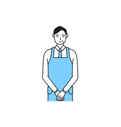 A Senior Man In An Apron Bowing With Folded Hands