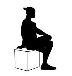 Man Sitting On Box With One Foot Up On Knee