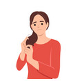 a young woman stressing over her dry frizzy hair vector image