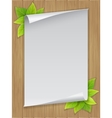 paper sheet and green leaves on wooden background vector image vector image