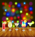 cocktails on wooden table and bar lights vector image