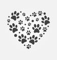 dark paw prints in heart shape vector image